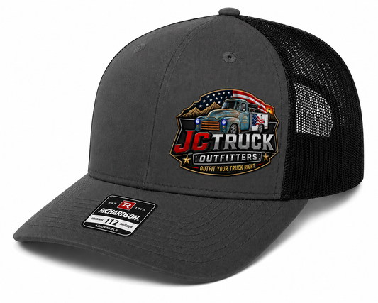 JC Truck Outfitters Richardson 112 trucker cap in charcoal and black with the full-color JC Truck Outfitters patch on the front