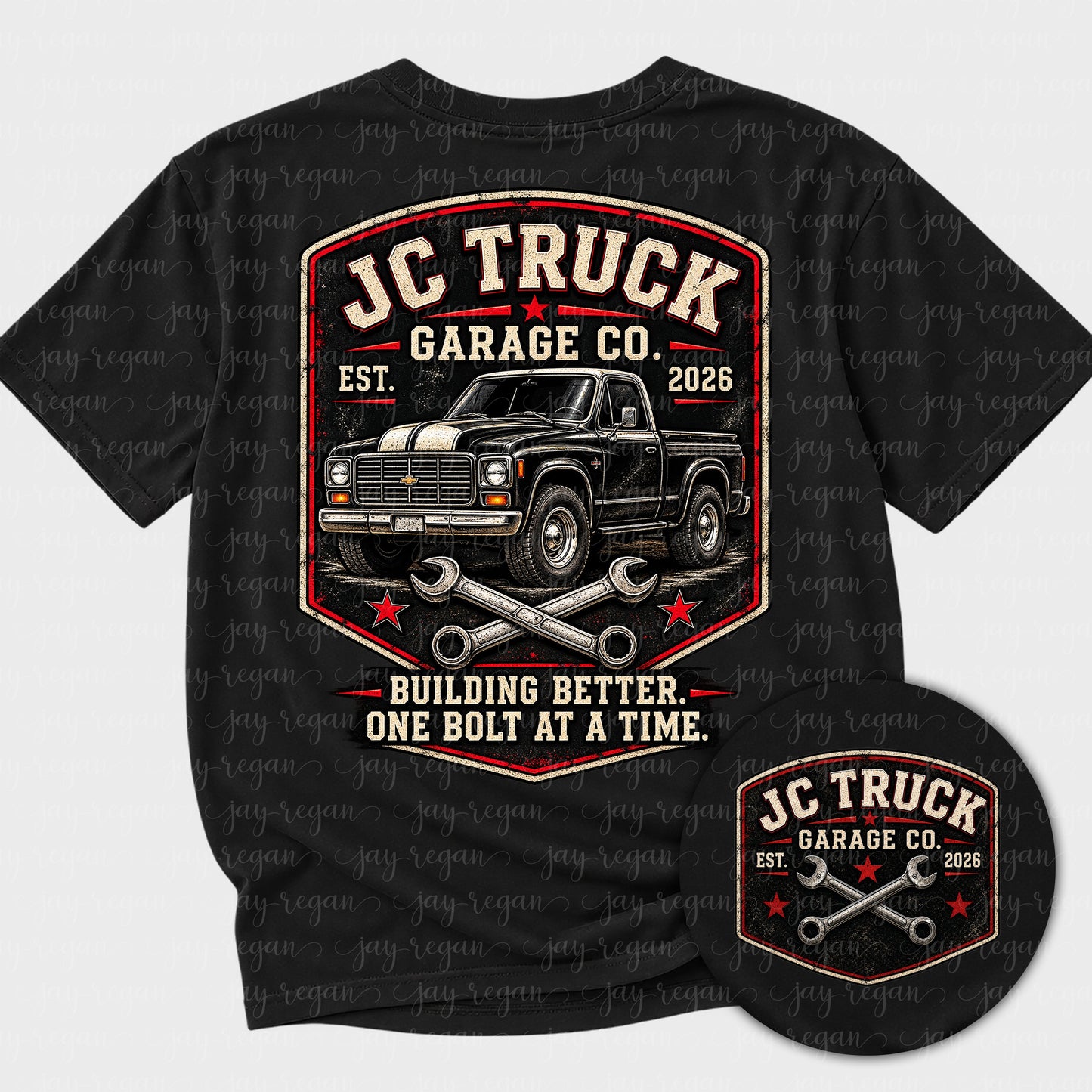 Black t-shirt with a full-back print: a vintage stepside pickup inside a worn shield badge with crossed wrenches, reading JC Truck Garage Co., Est. 2026, and Building better. One bolt at a time.